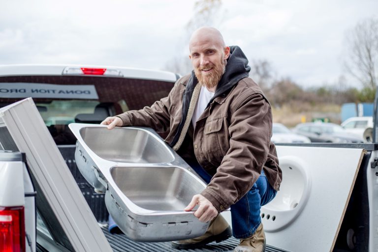 Man donating a sink to the Habitat ReStore.